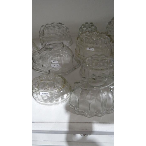 57 - Collection of twenty-one glass press-moulded jelly moulds, in various designs including a rabbit, 21... 