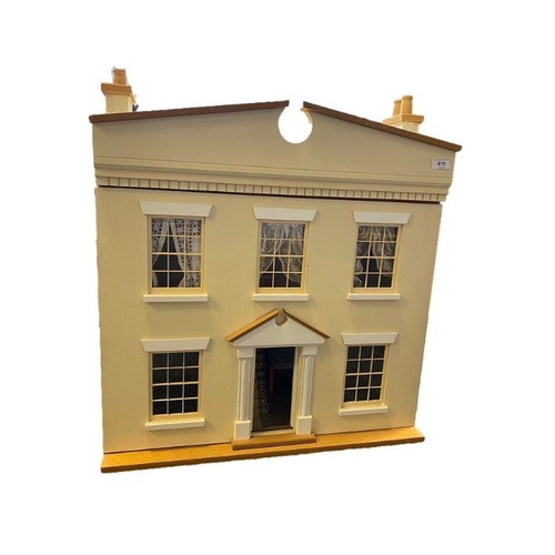 615 - Cream two story doll's house with a large collection of dolls, dolls house furniture to include cera... 