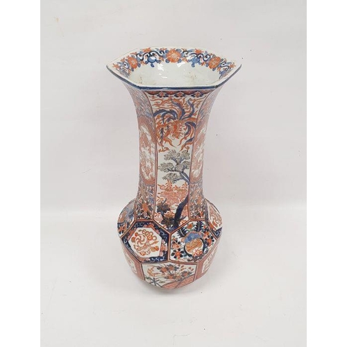 69 - Late 19th century Imari faceted baluster vase, with tall flared neck, painted with panels of preciou... 