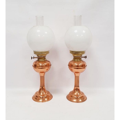 95 - Pair of copper and brass oil lamps, marked Duplex made in England, with their accompanying chimney a... 