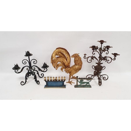 96 - Gilt metal model of a cockerel in full cry, a metal candle holder, and another, and two small menora... 