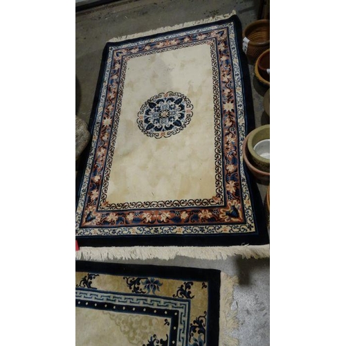 1043 - Three Chinese cream ground rugs, two 182cm x 124cm and one 273cm x 184cm