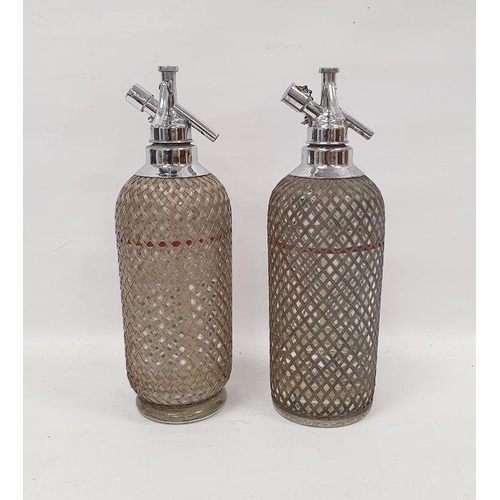 107 - Pair of soda syphons with silver coloured metal grille marked Sparklets Ltd. London