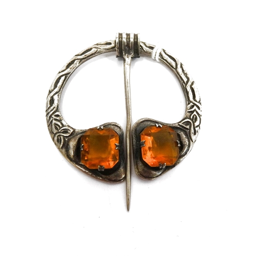 355 - Silver and citrine plaid brooch of Celtic form and set with two cut citrines, with movable pin, make... 