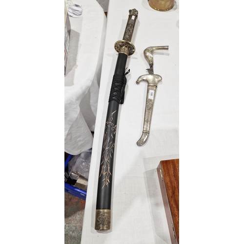 106 - Straight bladed kris with white metal sheath and handle, and a reproduction/modern wakizashi.