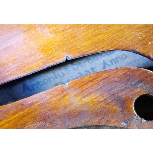 76 - Violin, in case, the pine top with scrolled sound holes, paper label inside 'Antonios Stradavarius A... 