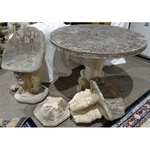 1360 - Composite stone circular garden table with incised floral decoration to the centre, on plinth base, ... 