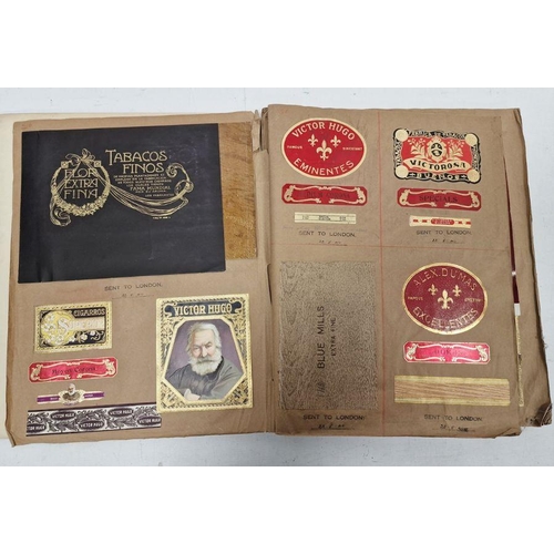 174 - Assorted ephemera to include cigar papers, wrappers, boxes, etc stuck down in book