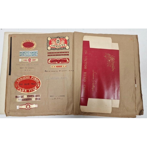 174 - Assorted ephemera to include cigar papers, wrappers, boxes, etc stuck down in book