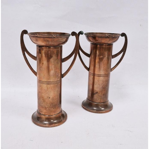 184 - Pair of Arts and Crafts copper two handled vases, each cylindrical with flared rim, stamped 'British... 