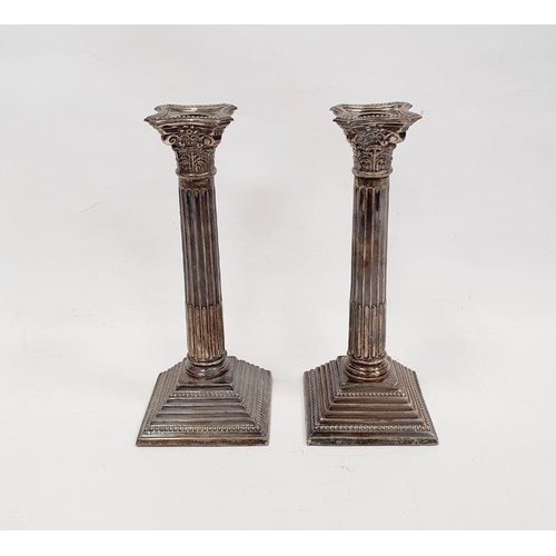 299 - Pair of 1960's silver weighted Corinthian column candlesticks with on a square stepped base, maker A... 