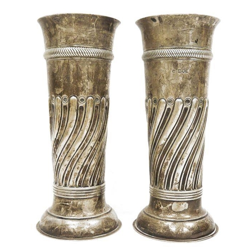 306 - Pair of Victorian large silver vases, cylindrical repousse decorated on circular feet, London 1897 a... 