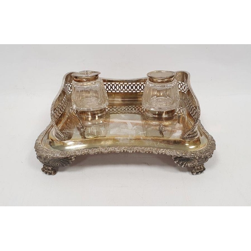 317 - George III silver inkstand with two glass and lidded silver inkwells, the shaped rectangular stand w... 