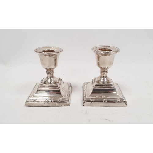 335 - Pair of George V silver weighted squat candlesticks with square stepped base, Chester 1910, maker's ... 