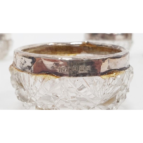 352 - Three silver-rimmed cut glass personal salts and six various silver napkin rings