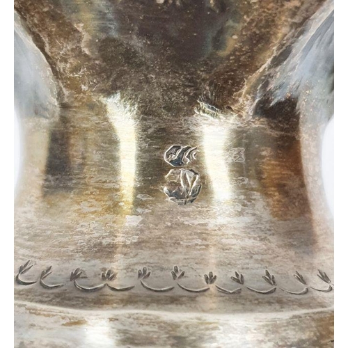 368 - Foreign silver-coloured metal tapering vase on a circular base, repousse floral decorated, indistinc... 