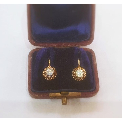 383 - Continental gold-coloured metal and diamond earrings, the circular old cut stone in ornate pierced f... 