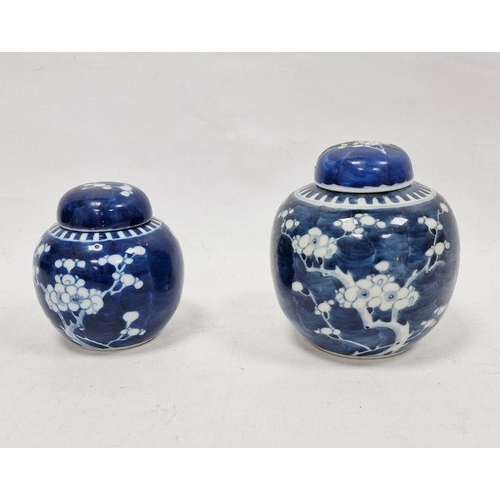 81 - Two Chinese blue and white prunus decorated lidded ginger jars, each with double-ring mark to base