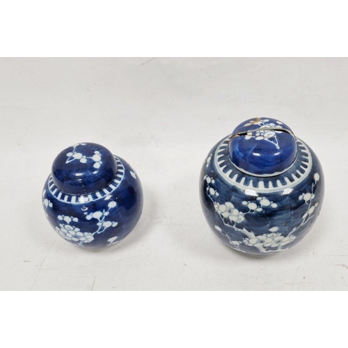 81 - Two Chinese blue and white prunus decorated lidded ginger jars, each with double-ring mark to base