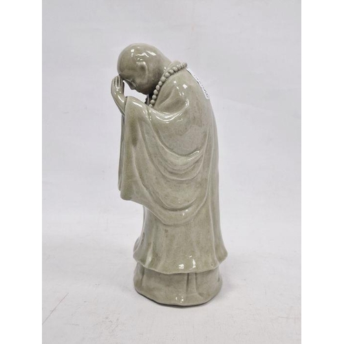 84 - Chinese ceramic figure of monk in prayer with faint mark to base, 24cm high