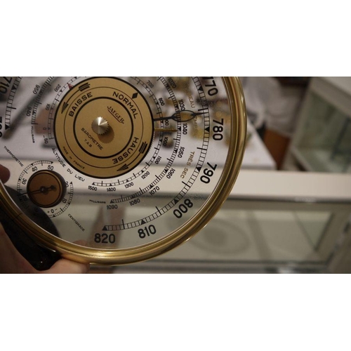 197A - Mid 20th century Jaeger desk barometer, of circular form, with gilt metal frame, the dial with a cen... 