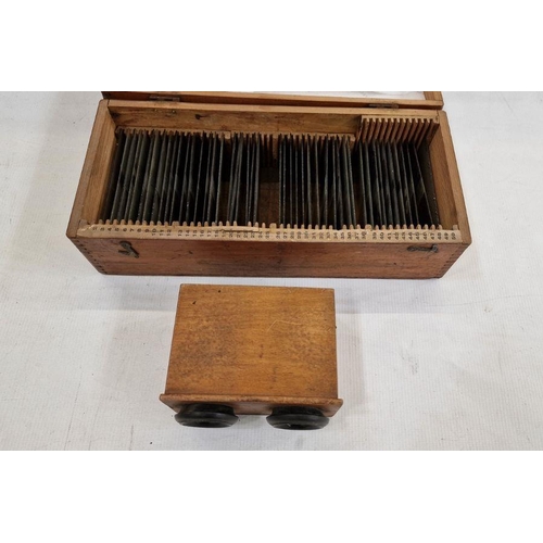 231 - A stereoscope with approximately forty-six glass slides depicting various WW1 trench and wartime sce... 