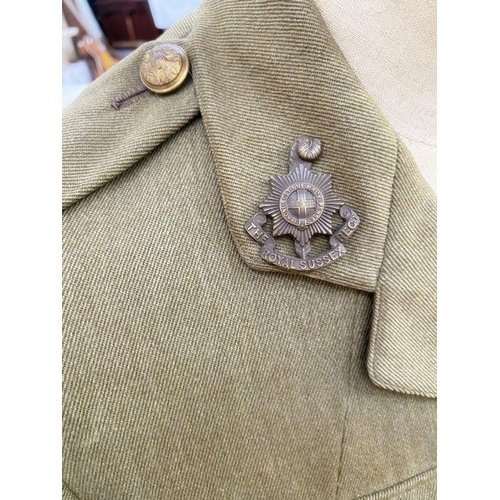 291 - WWI uniform jacket to an officer in the Royal Sussex Regiment, RAF cap with badge