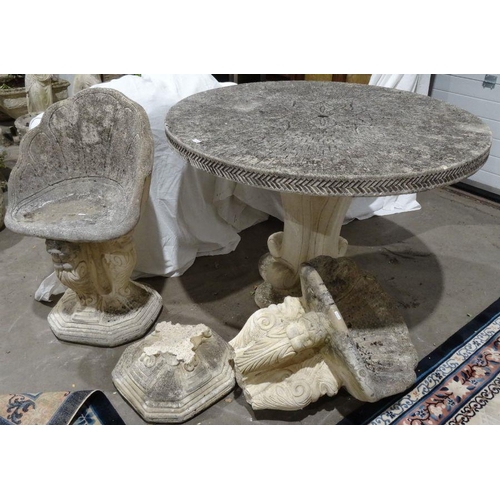 1299 - Composite stone circular garden table with incised floral decoration to the centre, on plinth base, ... 