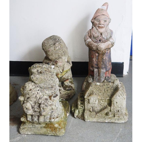 1300 - Four composite stone garden ornaments to include a gnome, a mill, a seated hedgehog and one further ... 