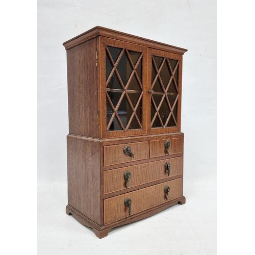 1014 - Miniature bookcase on chest of drawers with astragal glazed doors over two short and two long drawer... 