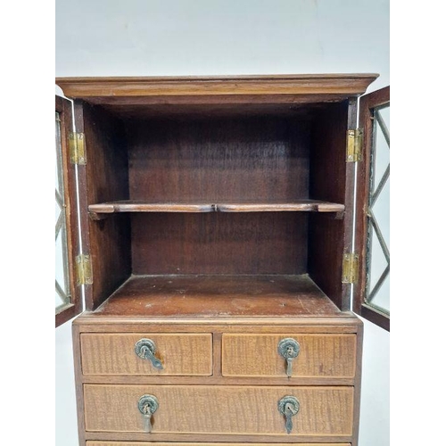 1014 - Miniature bookcase on chest of drawers with astragal glazed doors over two short and two long drawer... 