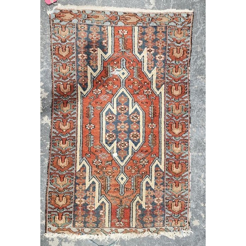 1040 - Eastern style red ground rug with central geometric medallion enclosed by floral pattern to a geomet... 