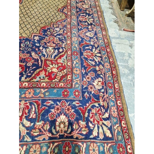 1052 - North East Persian Moud red ground carpet with large central floral medallion enclosed by geometric ... 