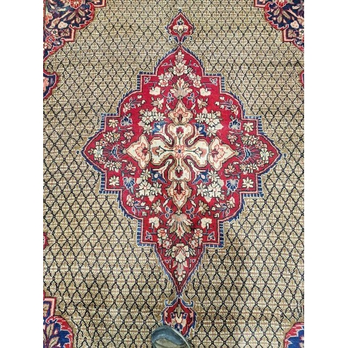 1052 - North East Persian Moud red ground carpet with large central floral medallion enclosed by geometric ... 