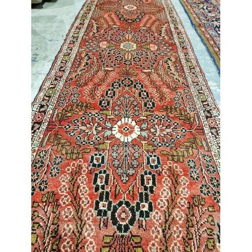 1054 - North West Persian Malayer red ground runner with one row of three floral medallions enclosed by flo... 