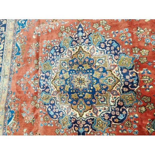 1059 - North West Persian Birjand red ground carpet with central floral medallion enclosed by floral patter... 