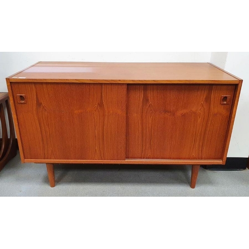 1073 - 20th century teak sideboard with two sliding doors above tapering stump feet H 73cm X W 122cm X D 51... 