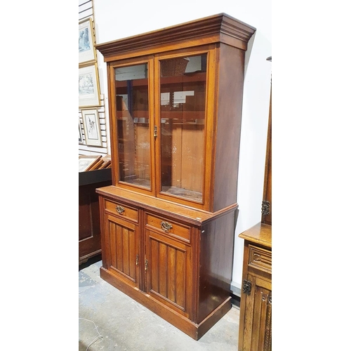 1144 - Late Victorian walnut bookcase with glazed double doors above two panelled frieze drawers and two pa... 