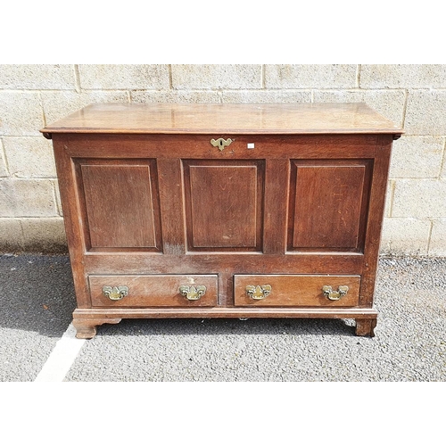 1145 - Oak Georgian-style mule chest with hinged plank top, above panelled front and sides and two drawers,... 