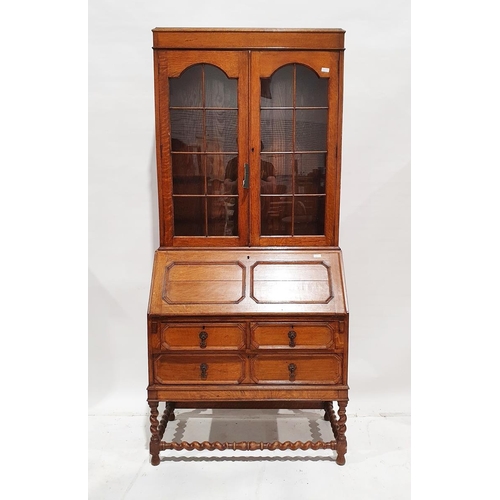 1148 - Oak bureau bookcase with glazed double doors above panelled fall front, revealing two drawers and pi... 