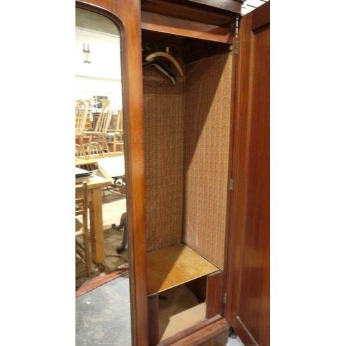 1151 - Victorian mahogany compactum with moulded cornice above three doors centred by a mirror, flanked by ... 