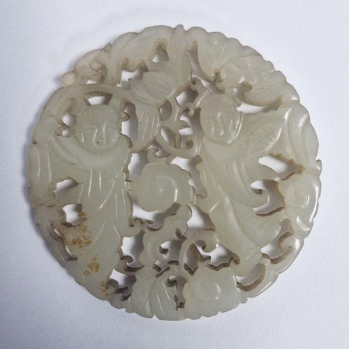 119 - Chinese pale celadon jade carved and pierced disc, bi-carved with two figures amongst scrolling flow... 