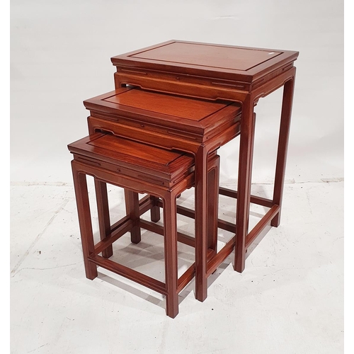 1191A - Nest of three modern Chinese rosewood occasional tables of rectangular form, on square section legs ... 