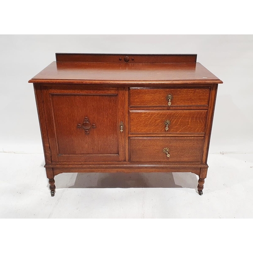 1205 - Oak sideboard, on rectangular moulded top above three drawers flanked by one cupboard, on turned and... 