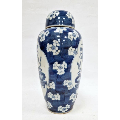 121 - Chinese lidded vase, the body of slight tapering form, blue and white set with panels featuring vase... 