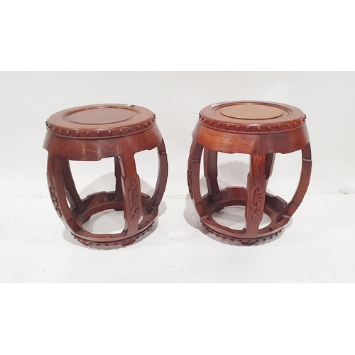 1263 - Pair Oriental hardwood barrel-shaped stools, each with four scroll carved curved supports, tab feet ... 