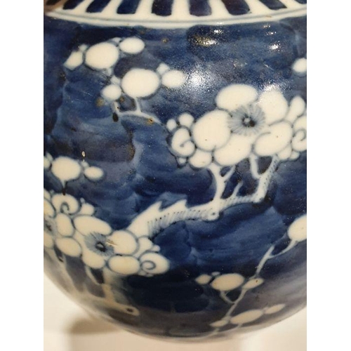 127 - Two Chinese blue and white prunus decorated lidded ginger jars, each with double-ring mark to base