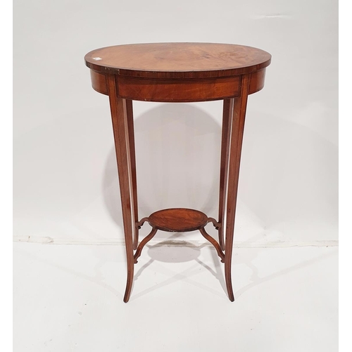 1298 - Edwardian flame mahogany oval two-tier occasional table with ebonised strung sabre legs