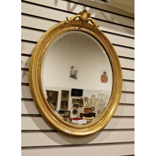 1327A - Modern oval gilt painted framed mirror with floral engraved detail