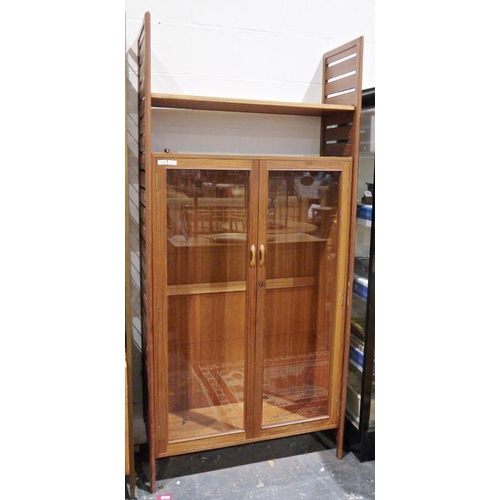 1328 - Ladderax teak display unit having wooden slatted sides, glass panelled doors, on straight supports, ... 